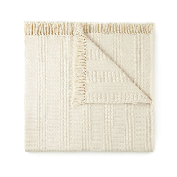 GOTS-certified organic cotton throw with hand-finished tassels