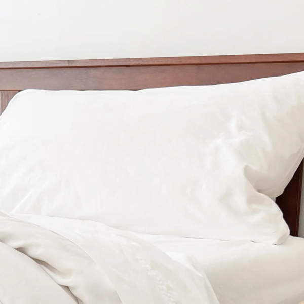 GOTS-certified organic cotton percale pillowcases on crisp white pillows