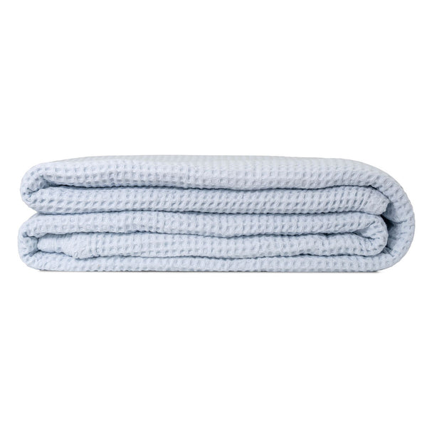 GOTS-certified organic cotton waffle weave throw folded over a chair