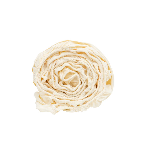 GOTS-certified organic cotton sateen fitted sheet on a made mattress